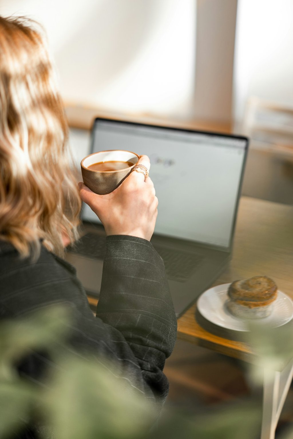 Professional working remotely from an apartment with coffee