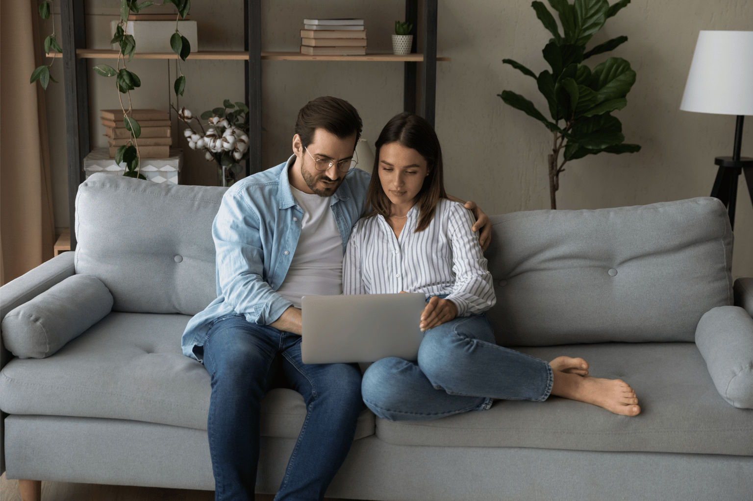 Couple reviewing property information on a sofa