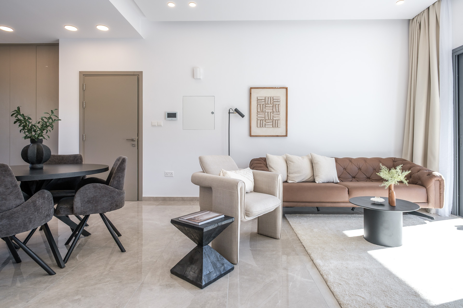 Modern furnished living room used as a hero image for property owners
